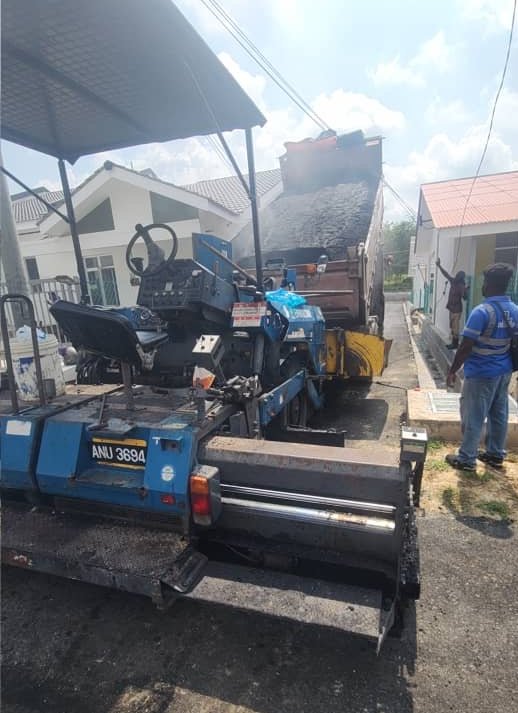 Premix being tipped into the paver hopper