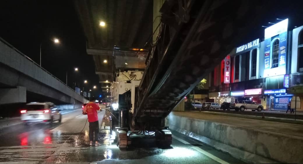 Milling the existing road surface at night